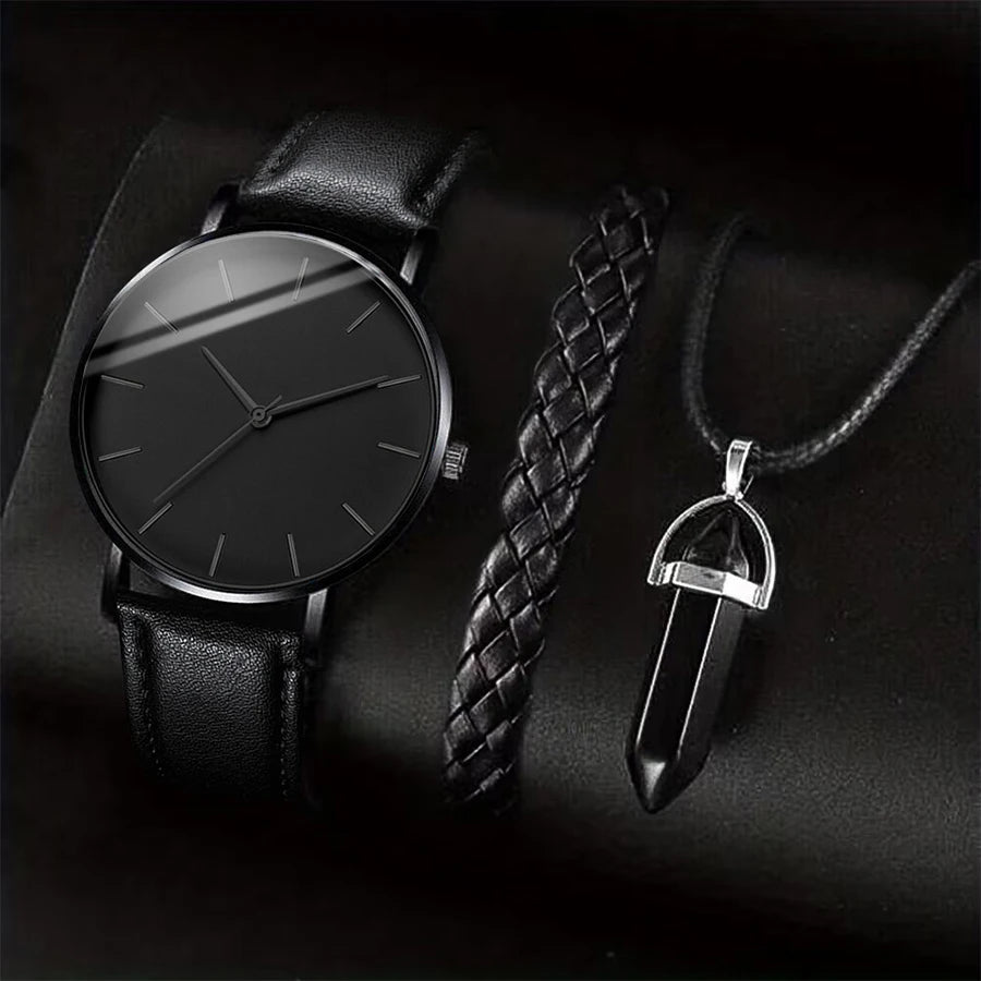 Black leather watch and pendant on a dark background