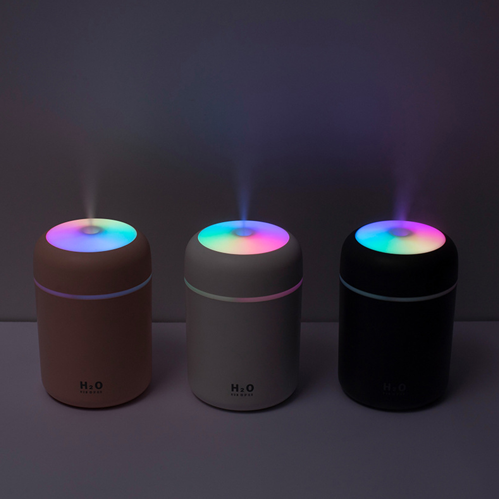 Three colorful humidifiers with 'H2O' branding on a dark background