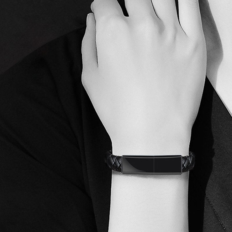 Black smartwatch on a wrist with a dark background