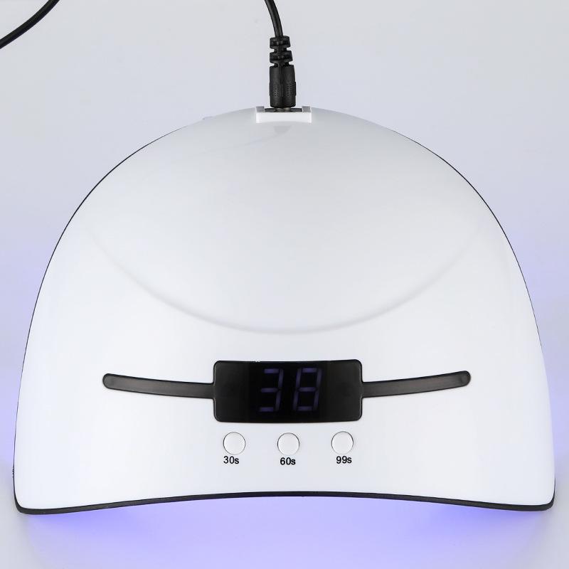 White nail dryer with digital timer on a white background