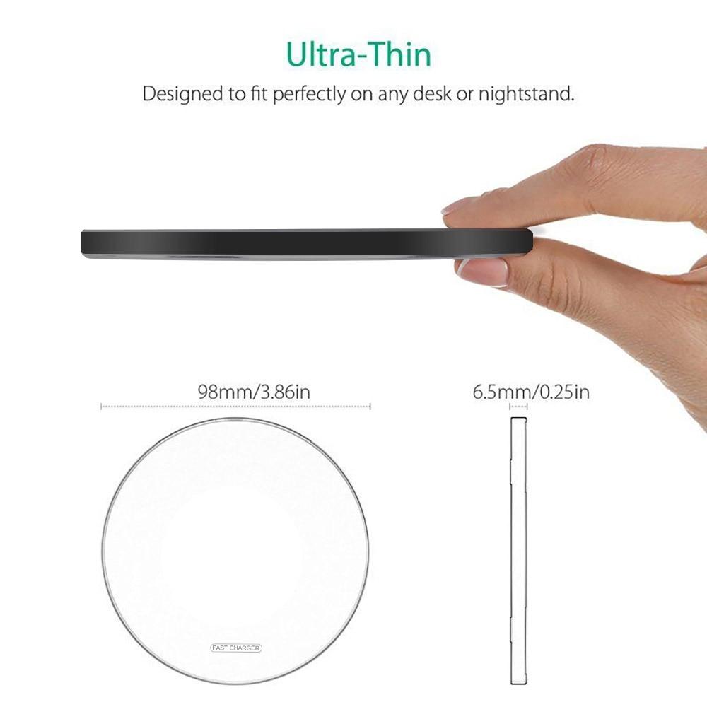 Thin black circular object held by a hand with measurements displayed.